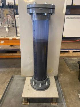 A black pipe with a black tube AI-generated content may be incorrect.